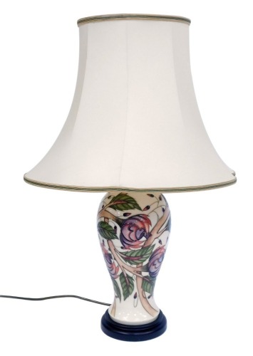 Appraisal: A Moorcroft table lamp on a cream ground with pink