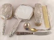 Appraisal: A white metal dressing table set comprising mirror two brushes