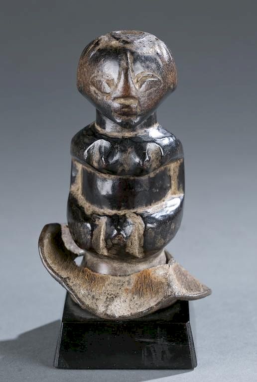 Appraisal: Seated female figure A seated female figure with metal collar