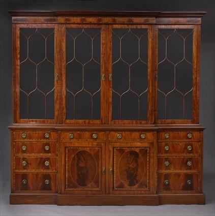 Appraisal: EDWARDIAN INLAID MAHOGANY BREAKFRONT BOOKCASE The flat top molded cornice