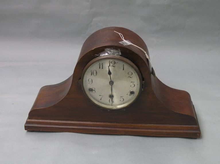 Appraisal: A mahogany mantel clock domed shape with silvered dial and