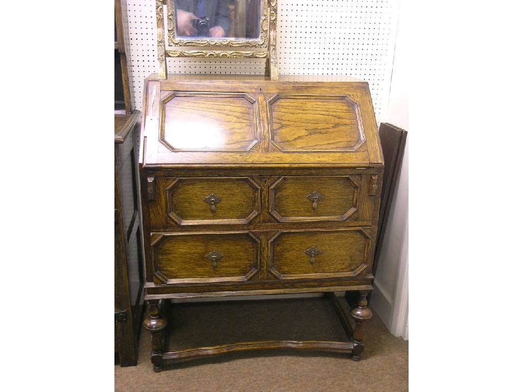 Appraisal: A 's solid oak bureau panel fall-front enclosing fittings above