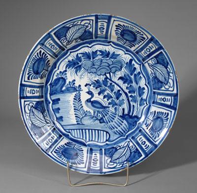 Appraisal: Delft charger central scene with peacock in woodland setting border