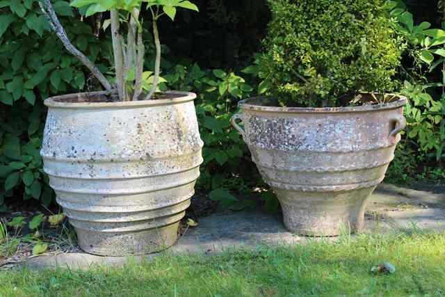 Appraisal: A SET OF THREE CRETAN TERRACOTTA TURNED OVOID PLANTERS with