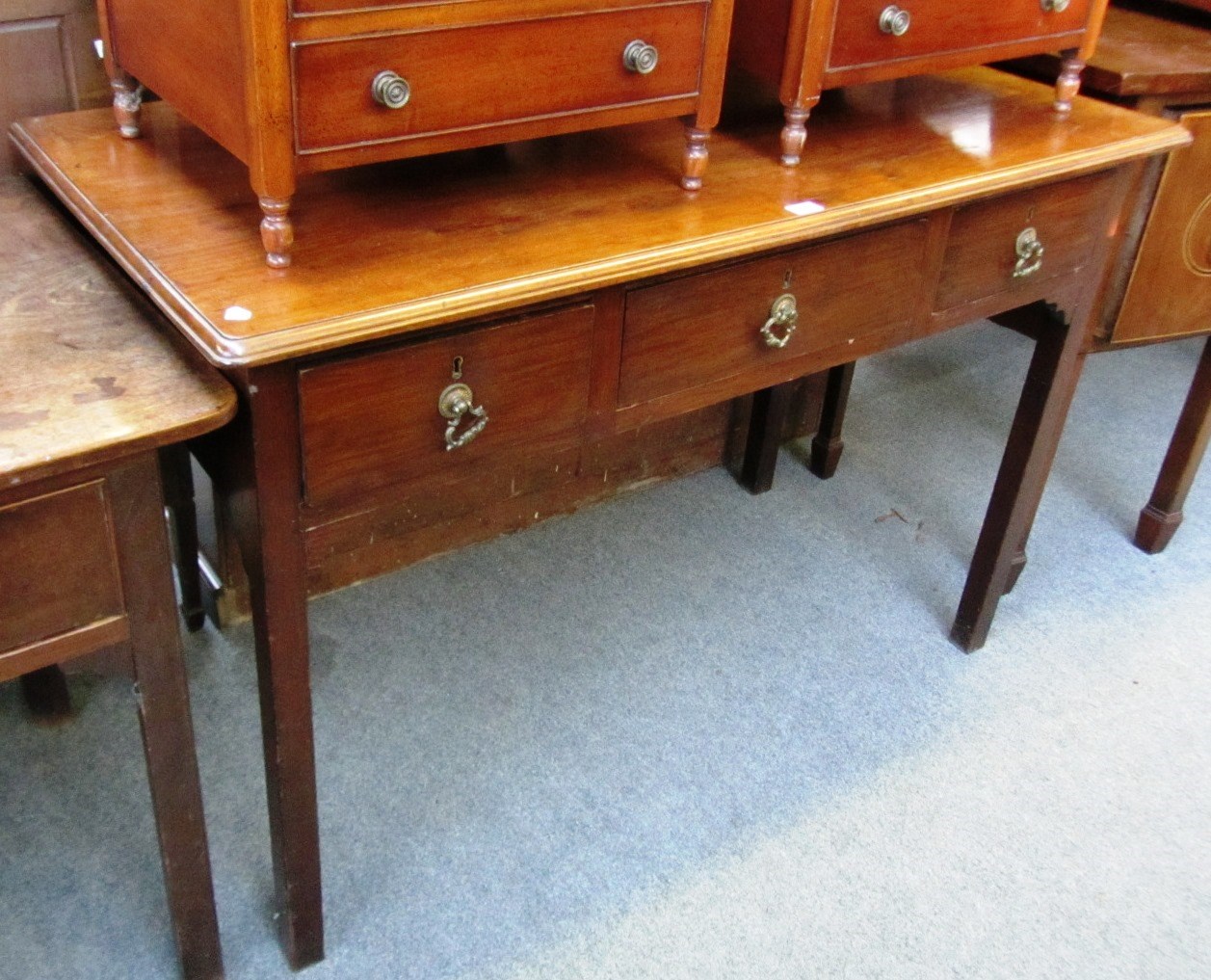 Appraisal: A George III mahogany serving table with three frieze drawers