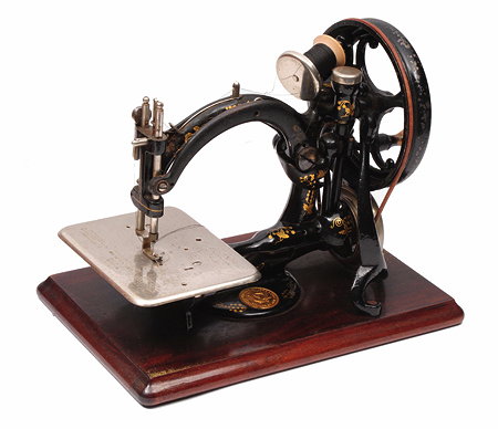 Appraisal: AN OLD WILLCOX AND GIBBS SEWING MACHINE on a mahogany