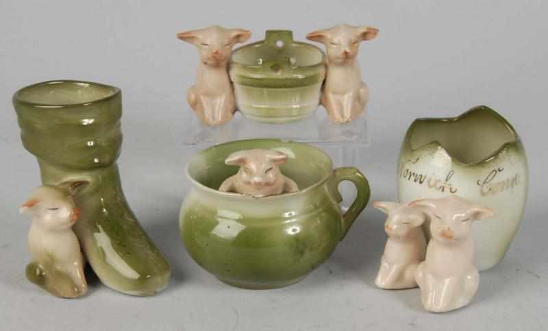 Appraisal: Lot of German Porcelain Pig Novelties Description Pig in a