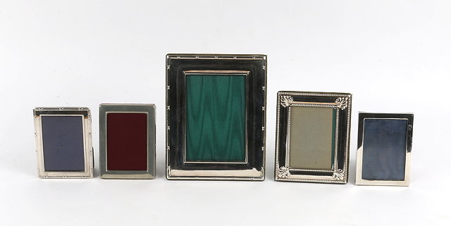 Appraisal: FIVE VARIOUS RECTANGULAR SILVER PHOTO FRAMES the largest with ribbon