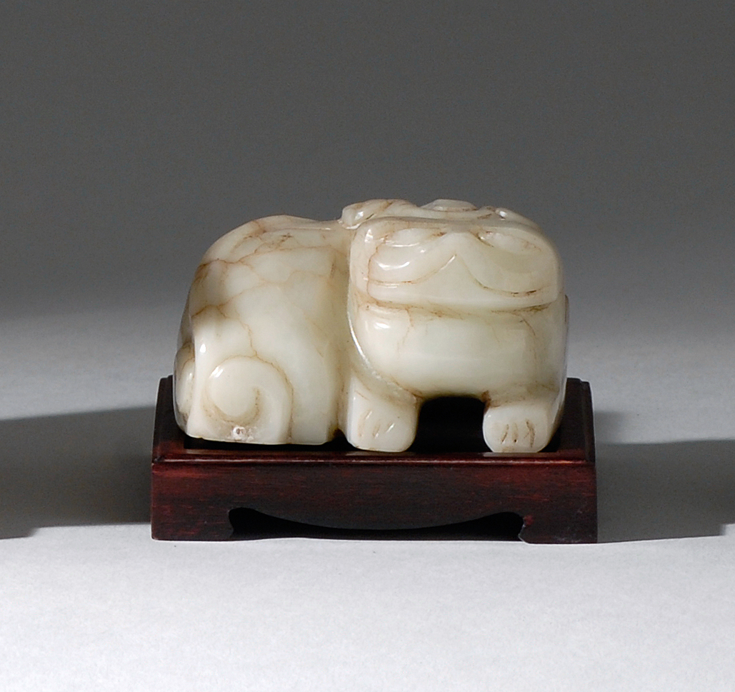 Appraisal: WHITE JADE FIGURE OF A LION Ming DynastyIn recumbent position