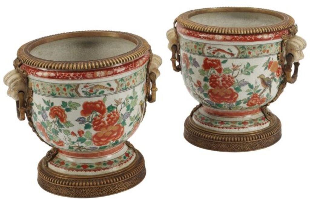 Appraisal: ORMOLU-MOUNTED PORCELAIN CACHEPOTS pair Porcelain cachepots with bronze dore mounts