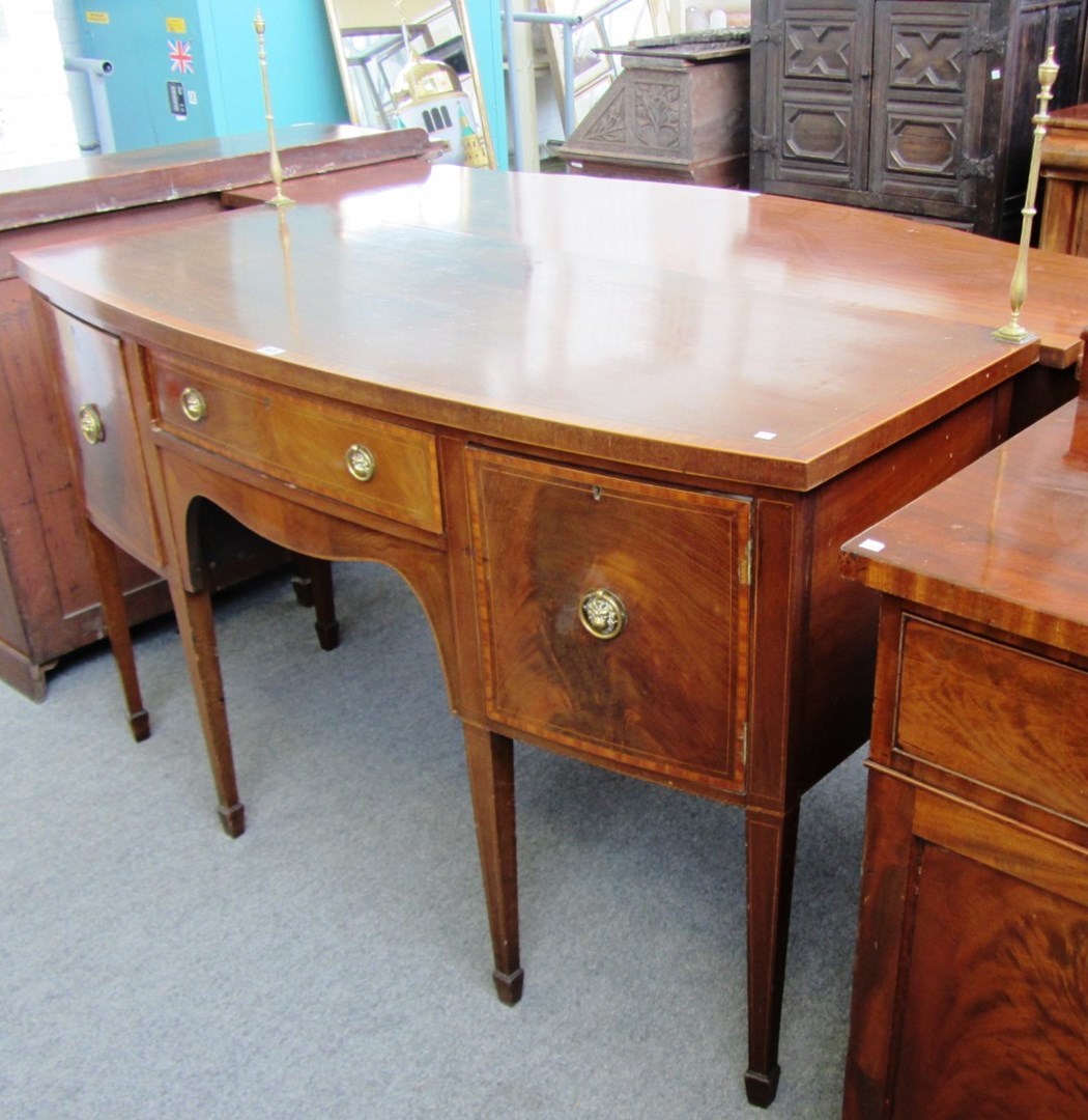 Appraisal: A George III style crossbanded mahogany bowfront sideboard with central