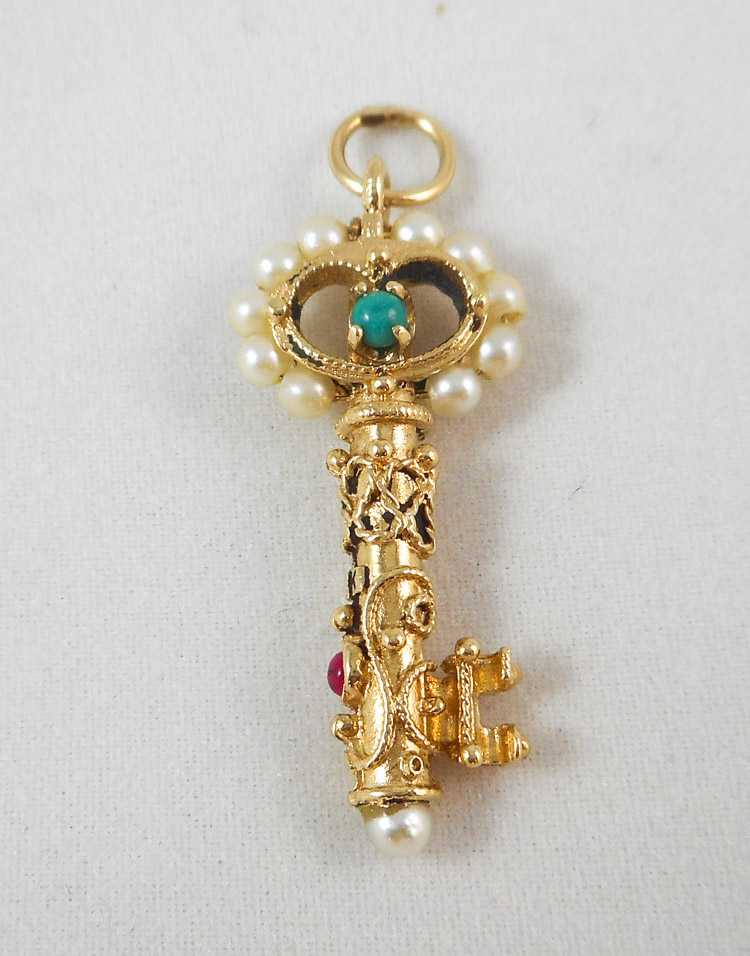 Appraisal: TURQUOISE AND SEED PEARL SKELETON KEY PENDANT k yellow gold