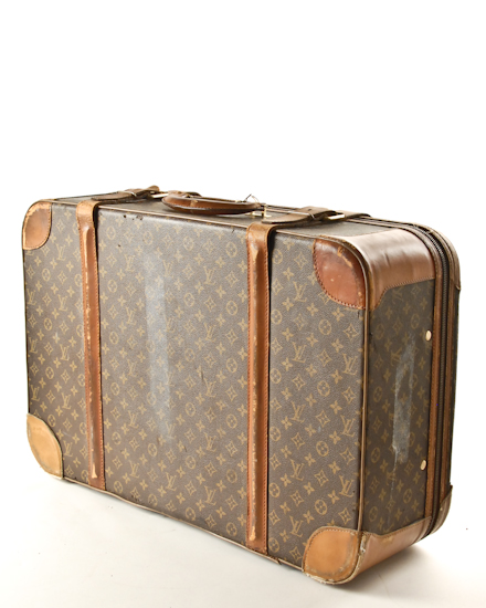 Appraisal: A Louis Vuitton Suitcase with scuffs and torn leather to