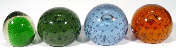 Appraisal: Four Whitefriars globular glass paperweights with bubbled centres and coloured