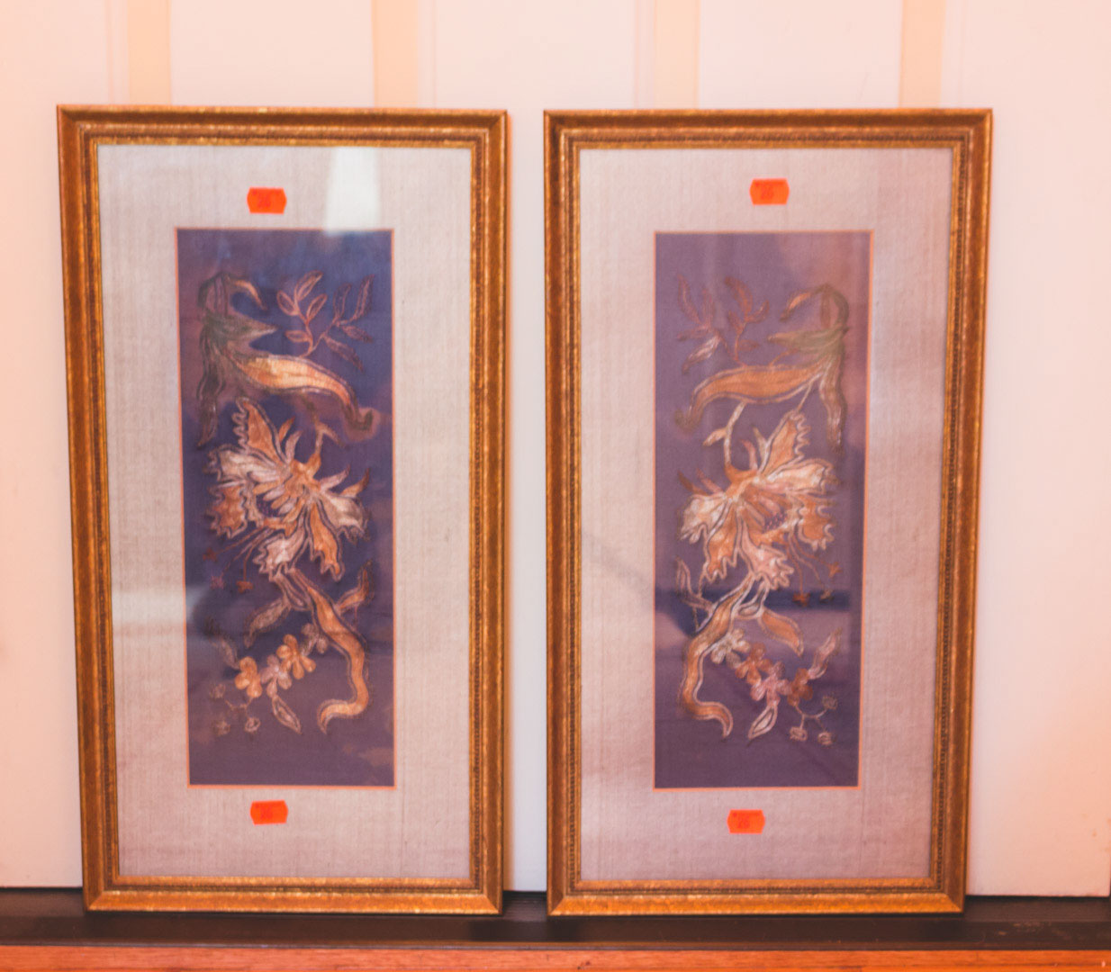 Appraisal: Pair of oriental style needlework panels each matted and framed