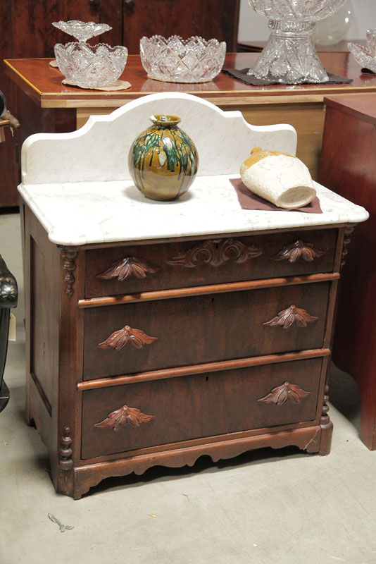 Appraisal: VICTORIAN COMMODE White marble top having a shaped gallery on