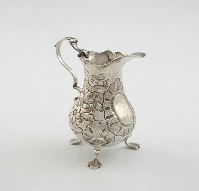 Appraisal: A George III embossed cream jug on three legs with