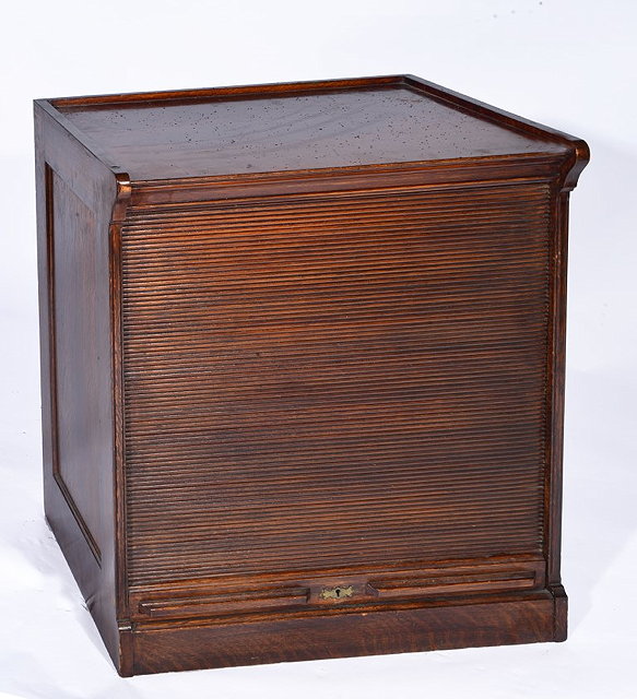 Appraisal: AN EDWARDIAN OAK FILING CABINET with vertical tambour shuttered door