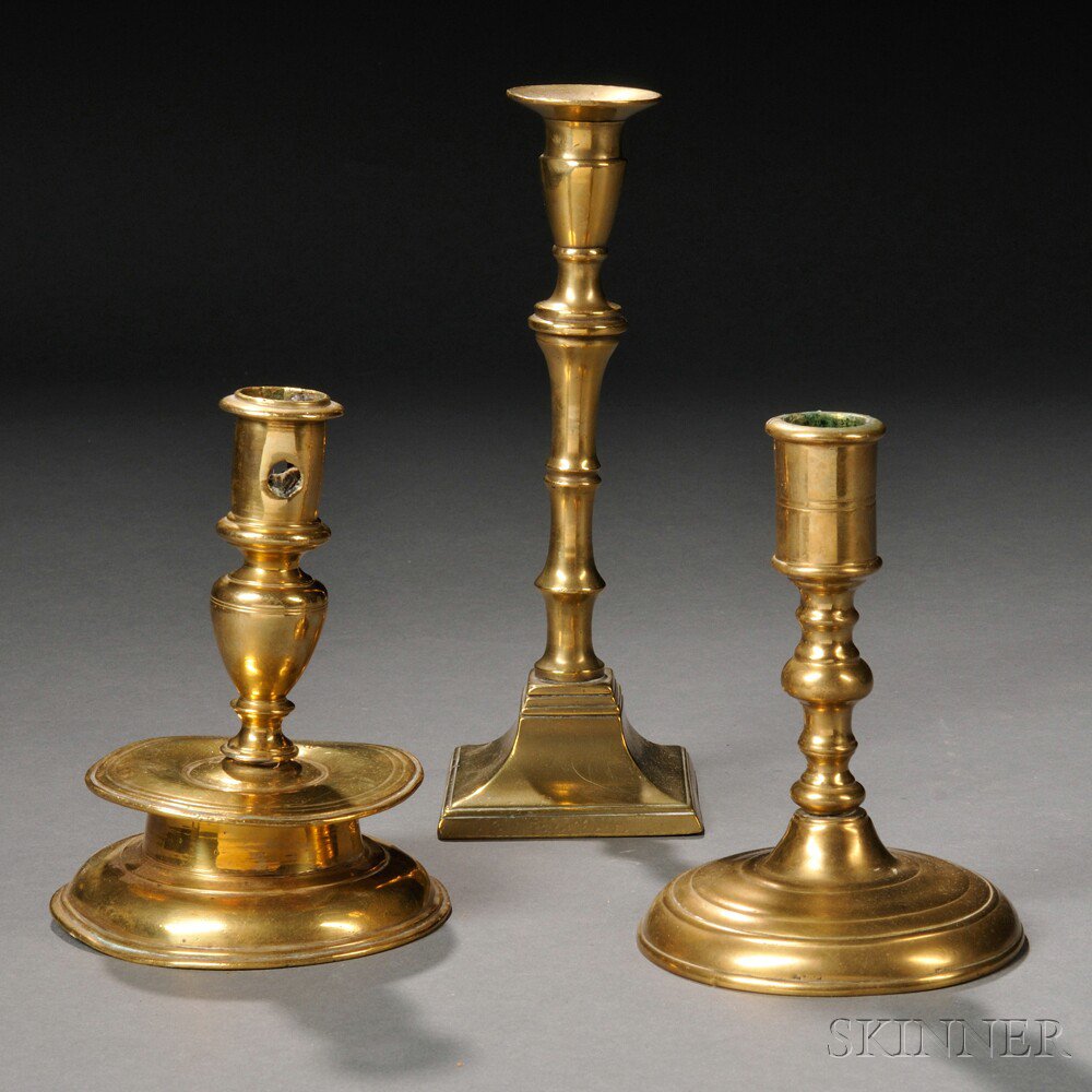 Appraisal: Three Early Brass Candlesticks a th century Spanish capstan candlestick