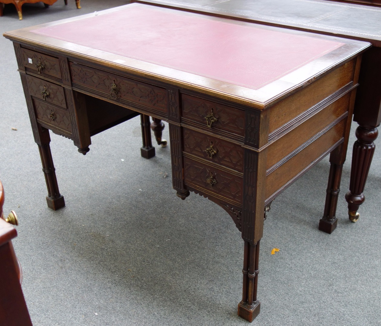 Appraisal: A late th century mahogany writing desk with seven drawers