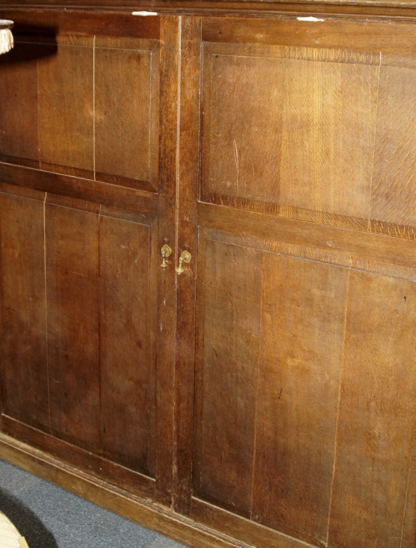 Appraisal: A thC oak housekeeper's cupboard enclosed by two panelled doors