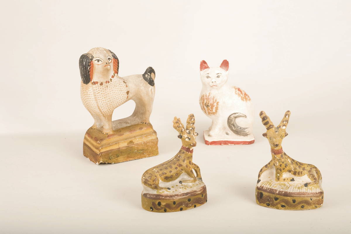 Appraisal: FOUR AMERICAN PAINTED CHALKWARE FIGURES OF ANIMALS Comprising a spaniel