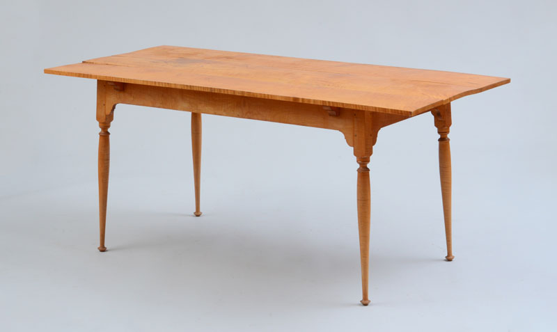 Appraisal: REPRODUCTION FIGURED MAPLE TEA TABLE in x ft in x