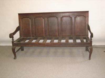 Appraisal: A GEORGE III OAK SETTLE th century moulded edge top