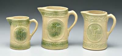 Appraisal: Three salt glaze quot stoneware quot pitchers grazing cows pattern