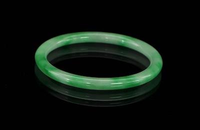 Appraisal: A Green Jadeite Bangle Rounded bangle bracelet measuring approx -