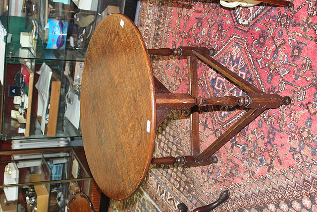 Appraisal: A TH CENTURY OAK CIRCULAR CRICKET TABLE the triangular base