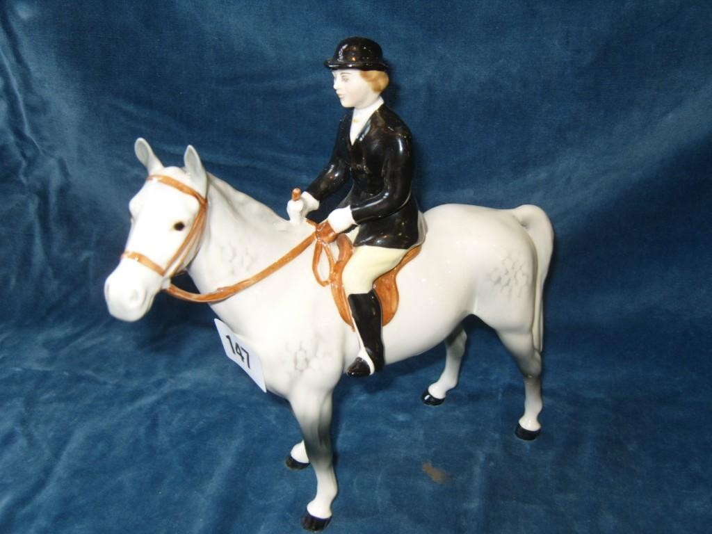 Appraisal: A Beswick model of a huntswoman in black jacket and