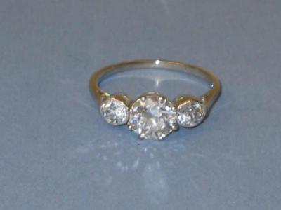 Appraisal: A THREE STONE DIAMOND RING the central brilliant cut diamond