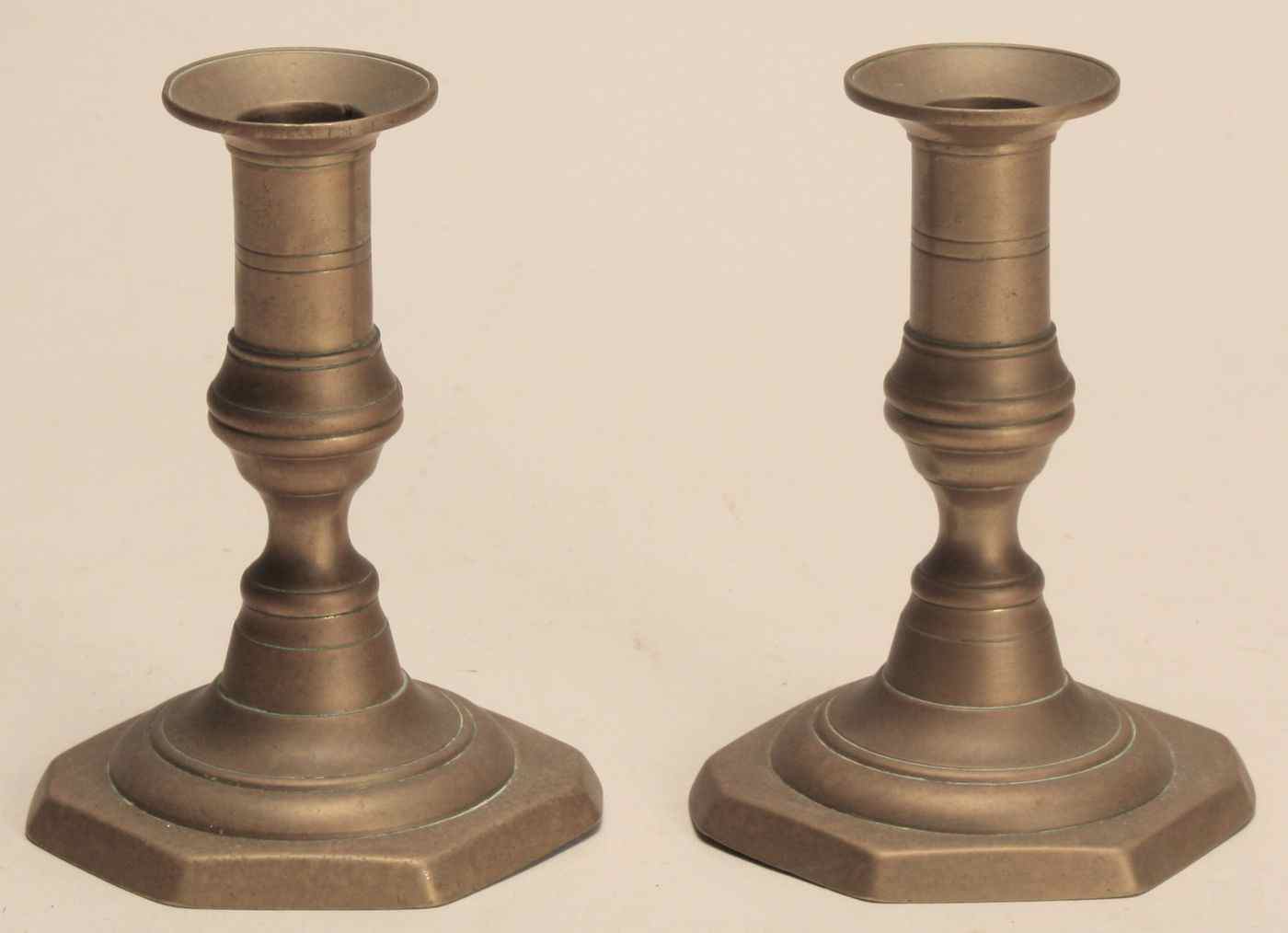 Appraisal: PAIR OF LOW BRASS PUSH-UP CANDLESTICKS th CenturyWith octagonal feet