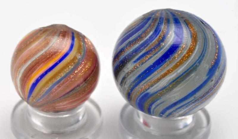 Appraisal: Lot of Onionskin Lutz Marbles Description The smaller marble is