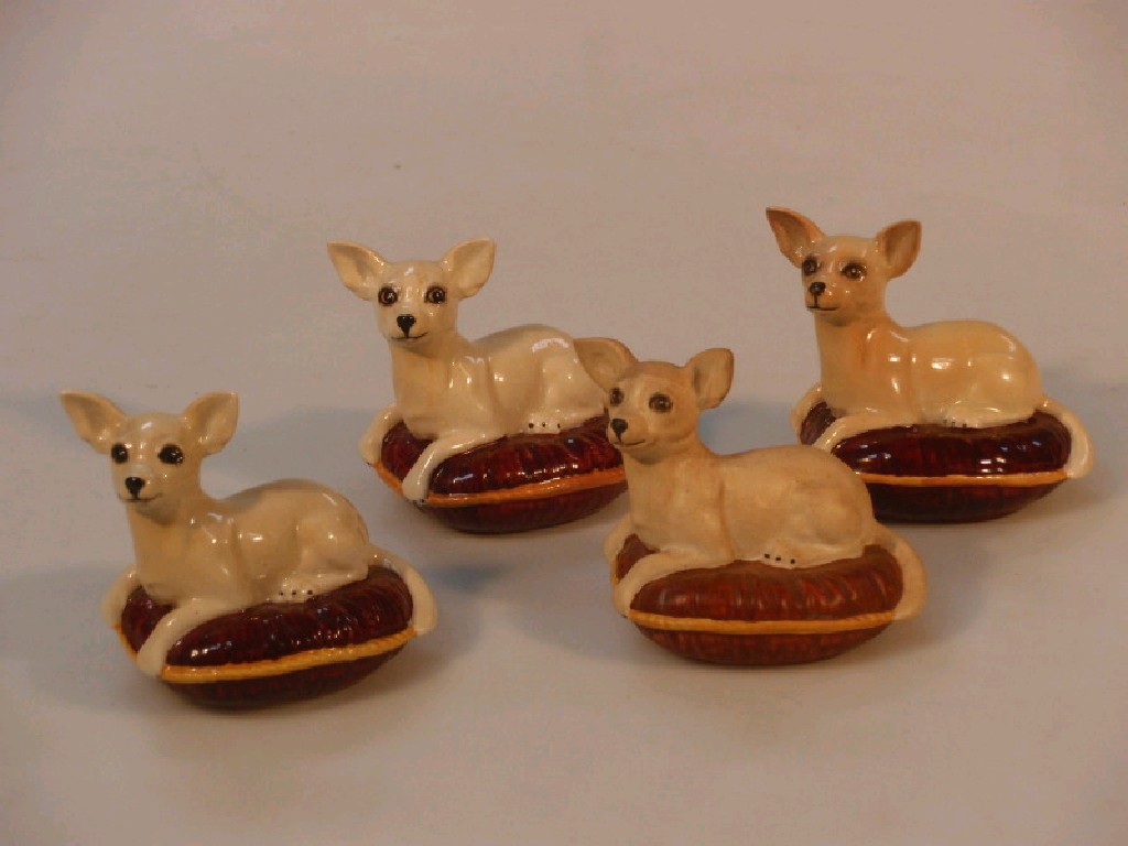 Appraisal: Four Beswick seated chiwawa on cushions cm