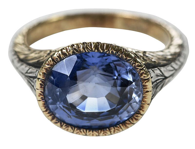 Appraisal: Silver and Gold Synthetic Sapphire Ring oval faceted synthetic blue