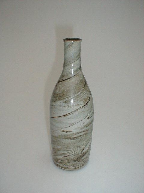 Appraisal: An agate stoneware bottle high paper label to base saying