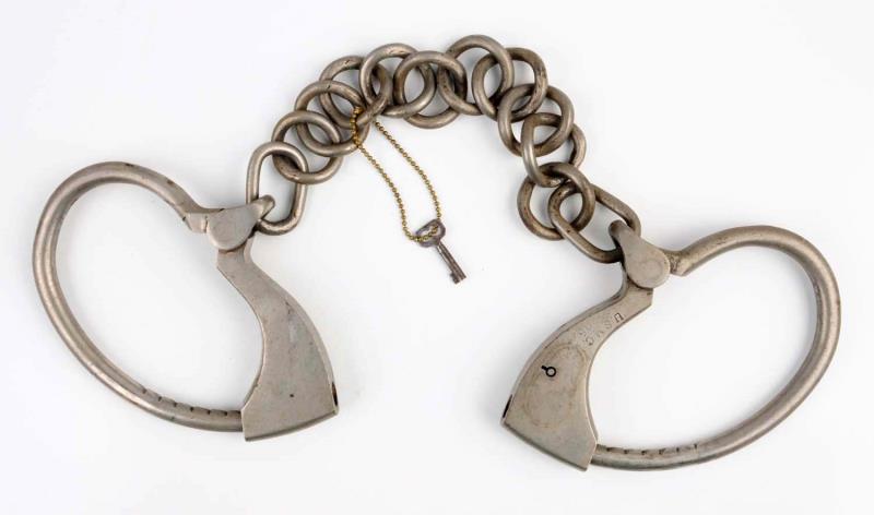 Appraisal: Tower Double Lock Leg Irons Includes key Marked USMC Nickel