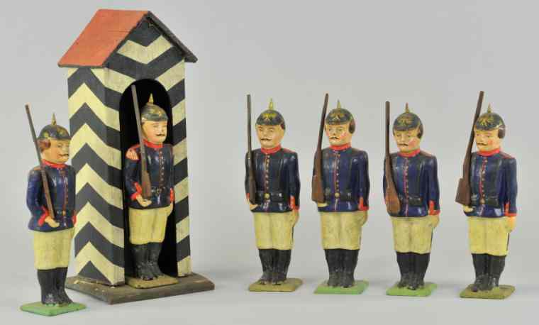 Appraisal: SENTURY HOUSE WITH SIX SOLDIER GUARDS Germany hand painted composition