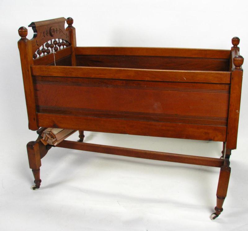 Appraisal: Victorian Walnut Baby Cradle with spring rocking mechanism stone castors