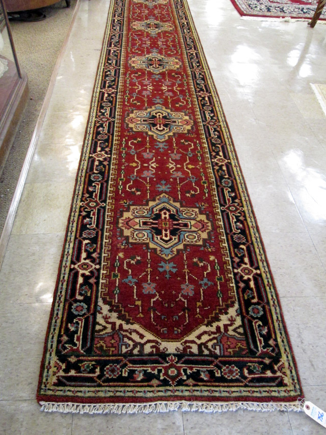 Appraisal: HAND KNOTTED ORIENTAL LONG RUG Indo-Persian having seven geometric medallions