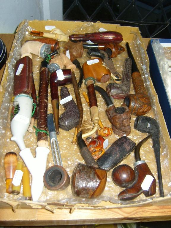 Appraisal: A quantity of various carved and other pipes including cased