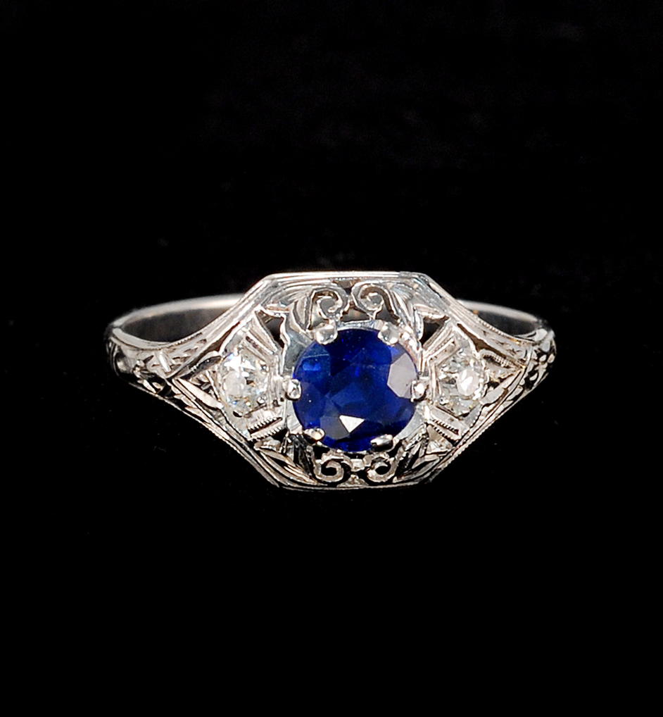 Appraisal: WHITE GOLD SAPPHIRE AND DIAMOND RING Central faceted round mm