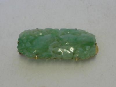 Appraisal: A JADE CLIP the rounded oblong panel carved with flowers