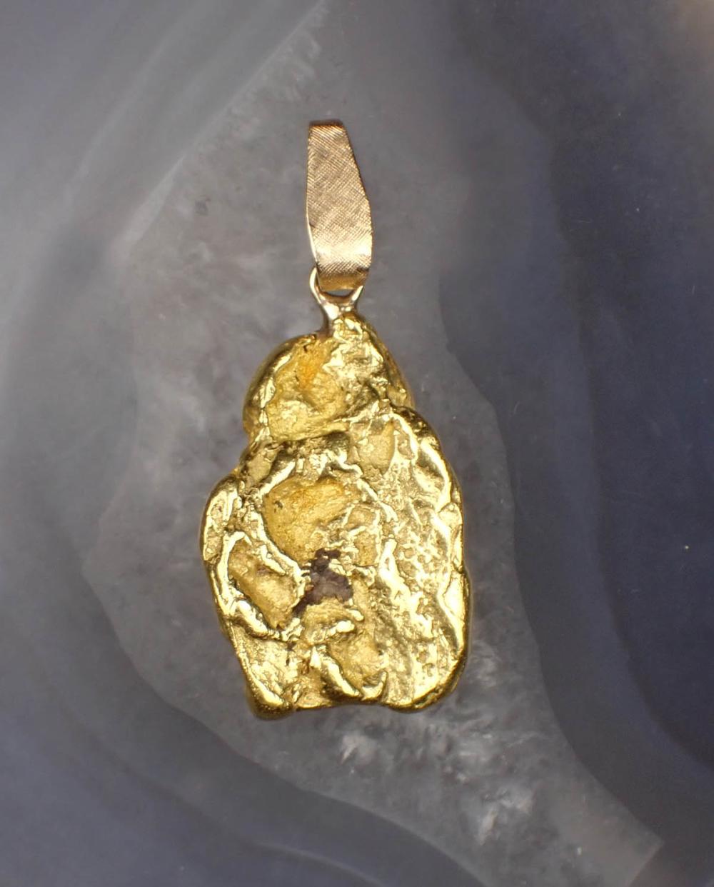 Appraisal: TWENTY ONE KARAT GOLD NUGGET PENDANT with a k yellow