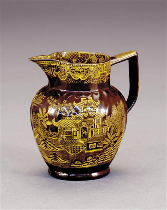 Appraisal: Rare English earthenware pitcher golden-yellow transfer-decorated in Oriental scenes on