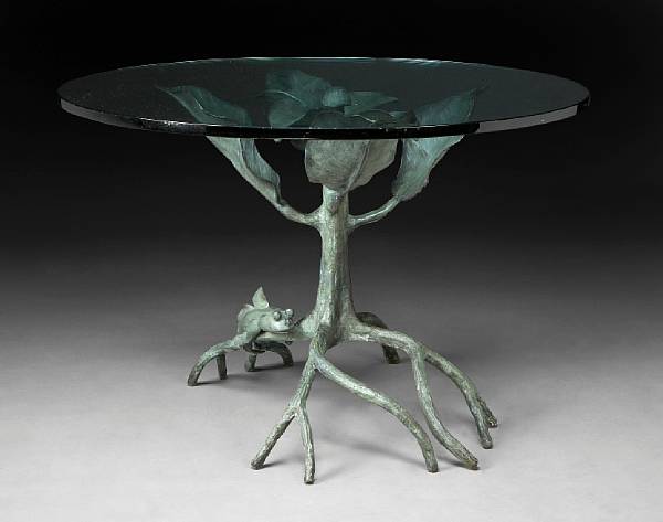 Appraisal: A patinated bronze and glass center table The circular top