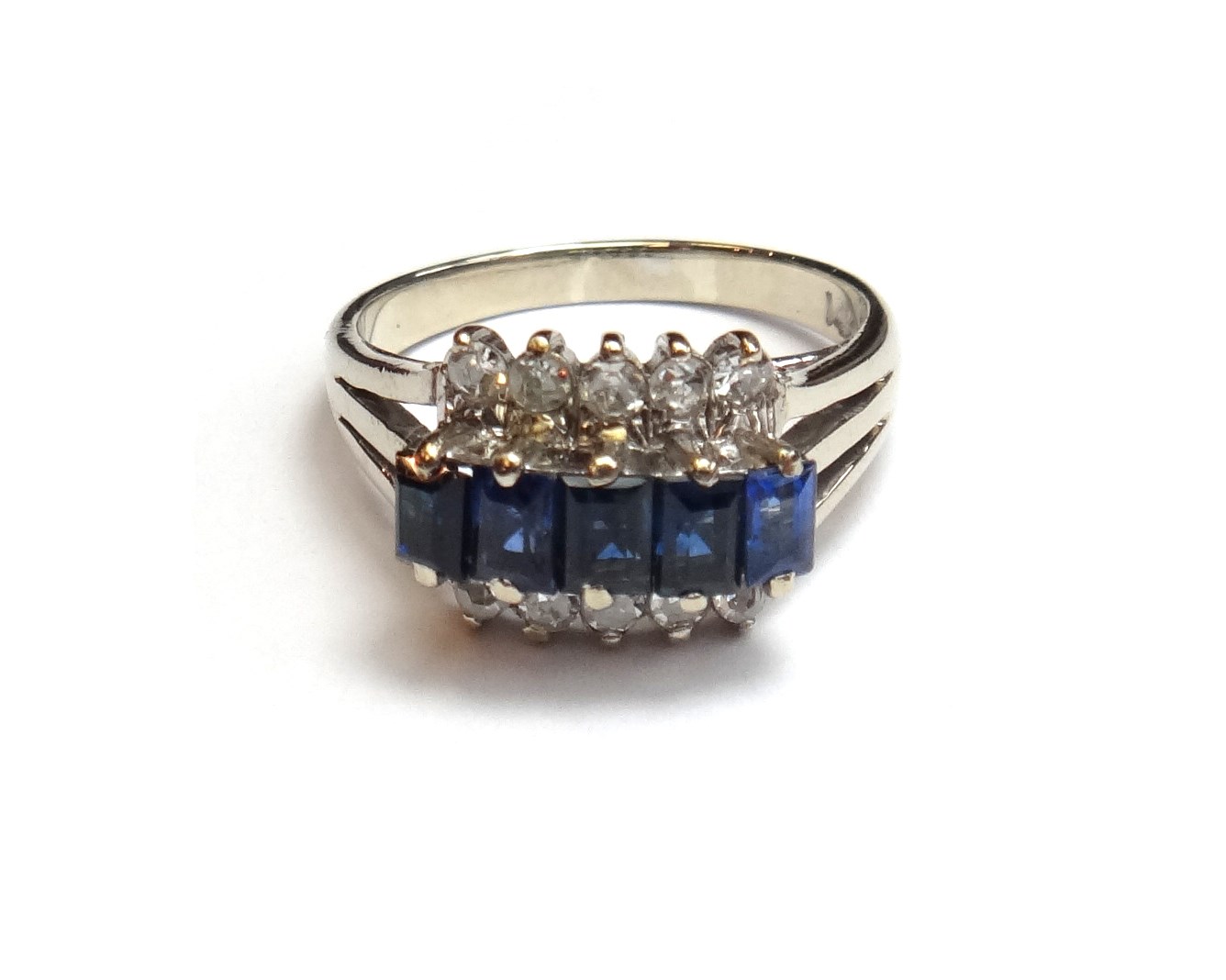 Appraisal: A white gold sapphire and diamond set ring claw set