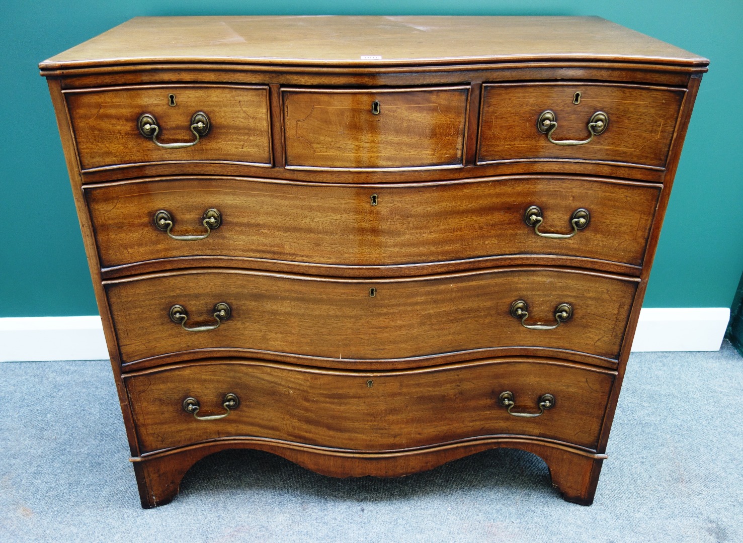 Appraisal: An th century style mahogany serpentine chest of three short